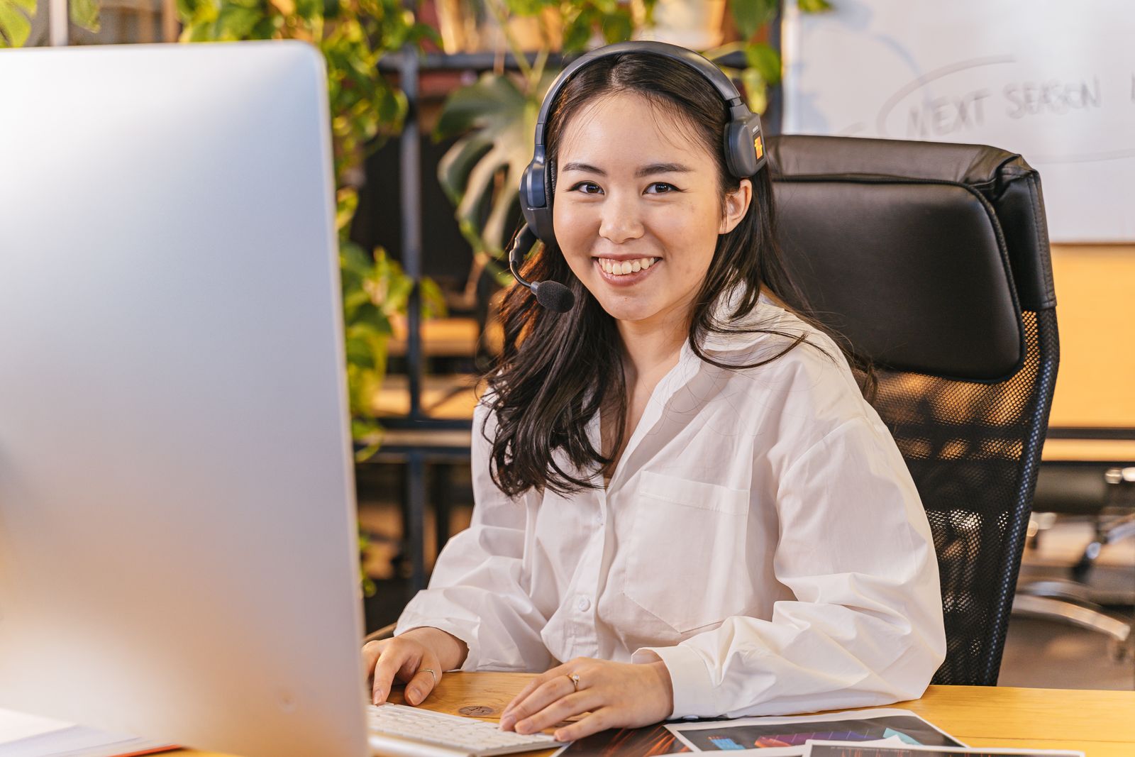 Office worker with a headset answering calls at a desk