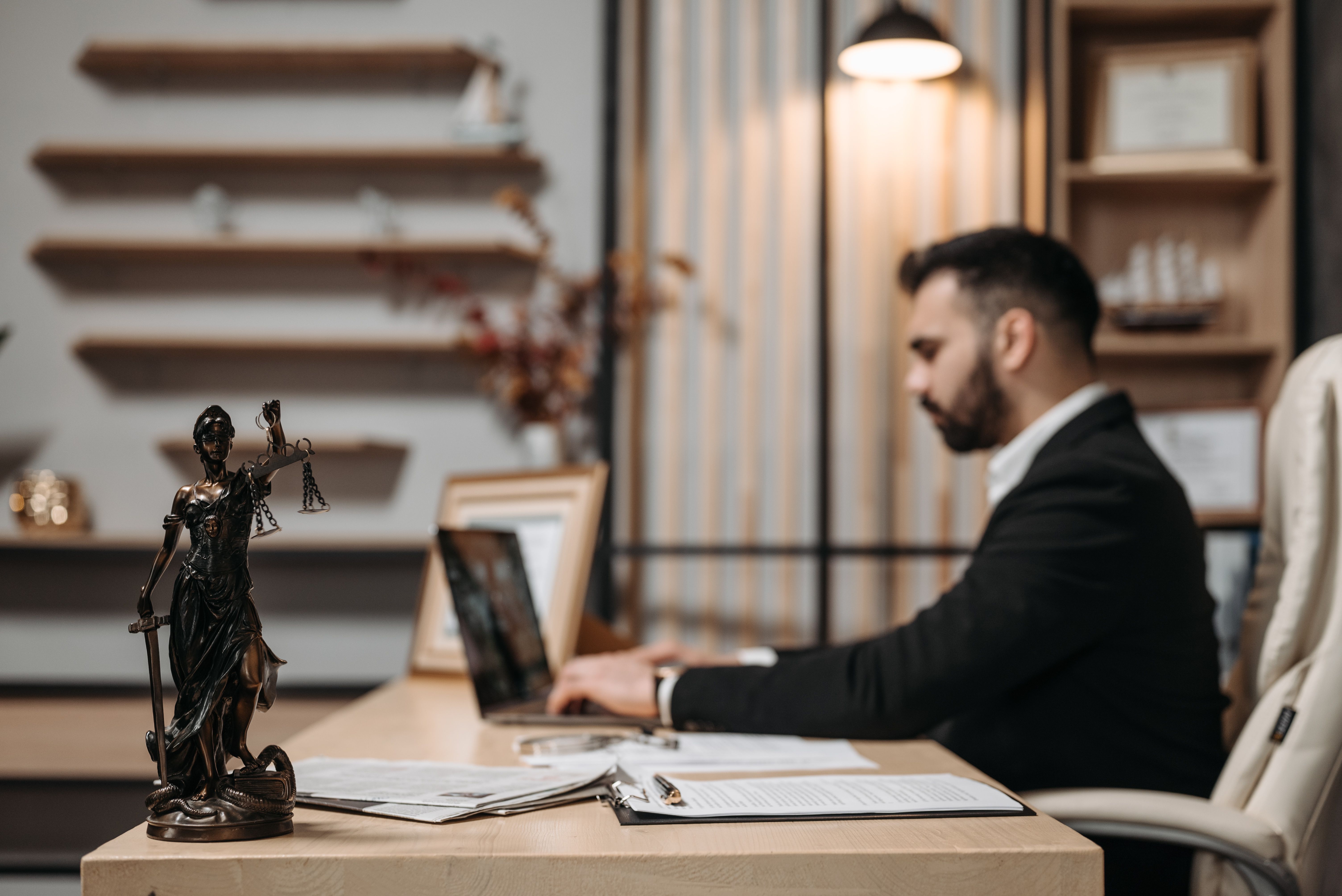 Attorney working at a laptop at an office desk